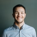 image of a man with blue shirt smiling